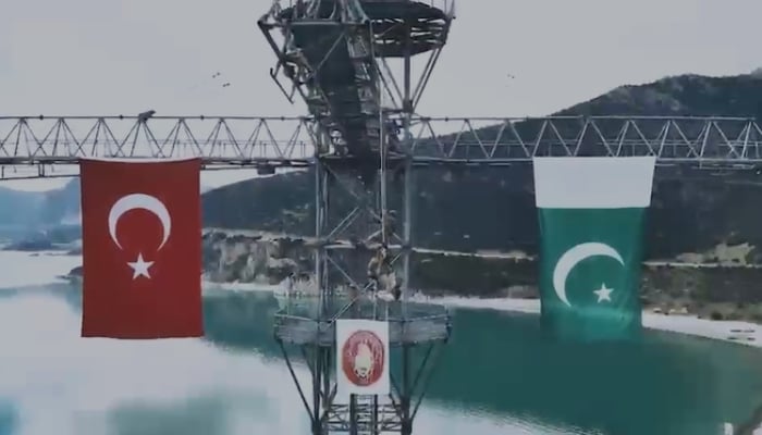 The Pakistan-Türkiye flags hanging on a bridge. —APP/File