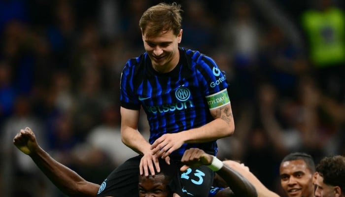 Nicolo Barella and Marcus Thuram can be seen celebrating. —AFP