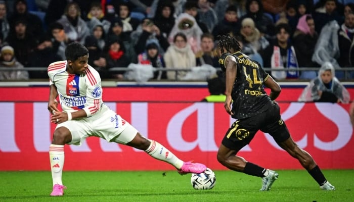 Lyons Brazilian forward Endrick (left) fights for the ball with Lorients Cameroonian defender Darlin Yongwa (right) during the French L1 football match between Olympique Lyonnais (OL) and FC Lorient at the Groupama Stadium in Decines-Charpieu, central-eastern France, on April 12, 2026. —AFP