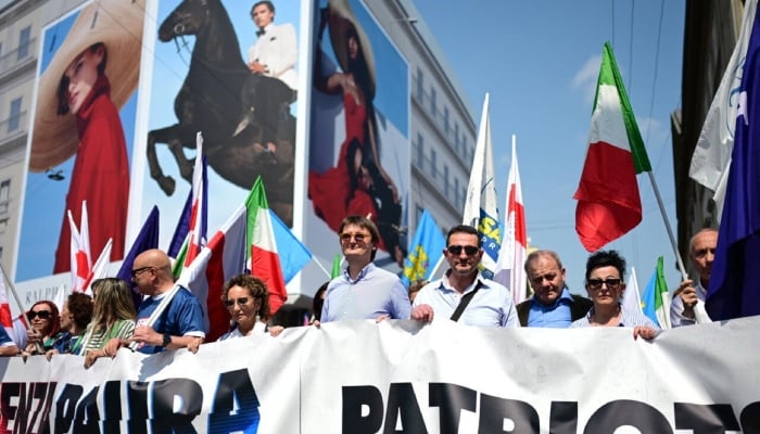 People march during a rally organized by the far-right group Patriots for Europe at the European Parliament in Milan on April 18, 2026. —AFP
