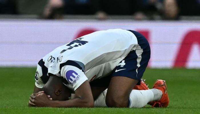 This picture shows Kevin Danso overwhelmed by the pressure or outcome of the match. —AFP