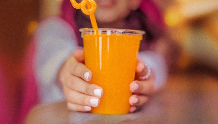 Representational image of a child holding a glass of juice. —TheNews/File