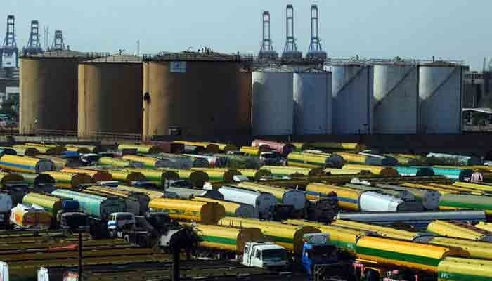 An overview shows tankers parked outside a local oil refinery in Karachi on February 22, 2011. —AFP