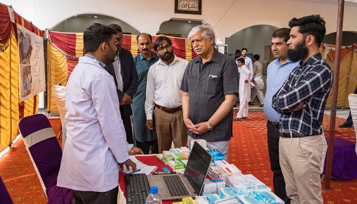 President Al-Shifa Trust, Maj Gen (Retd) Rehmat Khan visits the camp. — APP/File