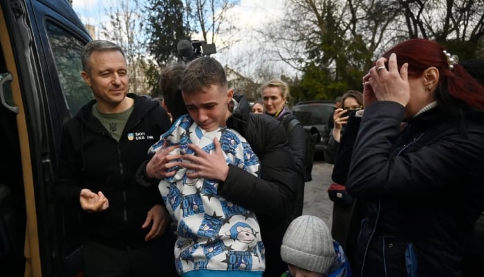 Photo for illustrative purposes only. Ukrainian woman Inessa (right) meets her son Vitaly after he and over a dozen of other Ukrainian children were brought back from Russian-held territory to Kyiv on March 22, 2023. —AFP