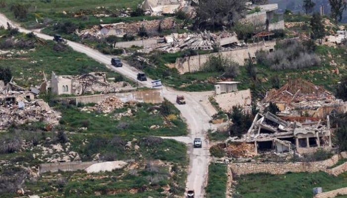Above, Israeli military vehicles drive along the road in the southern Lebanon near the border with Israel on April 17, 2026. —AFP
