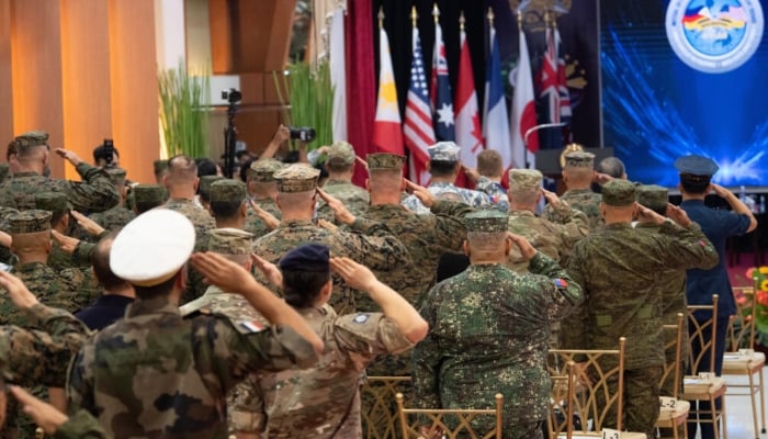 Philippine and US soldiers salute as their national anthems are played during the opening ceremony of the annual Balikatan military exercise at Camp Aguinaldo in Manila on Monday. —AFP