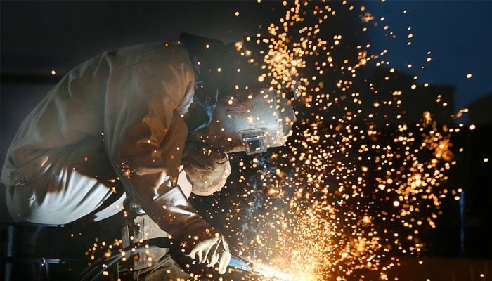 A worker works on a production line at a factory of a ship equipment manufacturer, in Nantong, Jiangsu province, China March 2, 2020.—Reuters