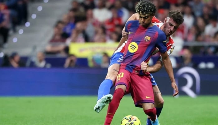 Barcelonas Spanish forward Lamine Yamal (left) and Atletico Madrids Italian defender Matteo Ruggeri fight for the ball during the Spanish league football match between Club Atletico de Madrid and FC Barcelona at Metropolitano Stadium in Madrid on April 4, 2026.— AFP