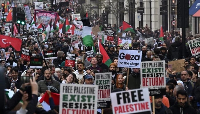 People walk down Regent Street as they take part in a March For Palestine in London on October 14, 2023. —AFP
