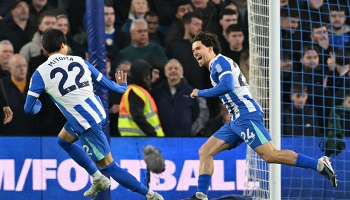 Brighton defender Ferdi Kadioglu (right) celebrates with teammate Kaoru Mitoma after scoring the opening goal against Chelsea at the American Express Community Stadium in Brighton, England, on Tuesday.— AFP