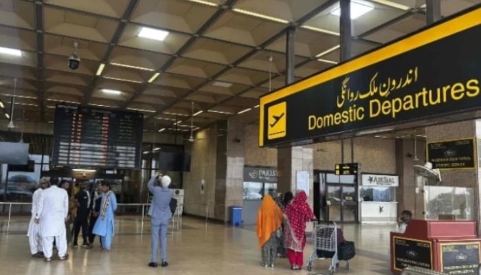 Passengers wait at the Jinnah International Airport after all domestic and international flights were cancelled in Karachi on May 7, 2025. — AFP