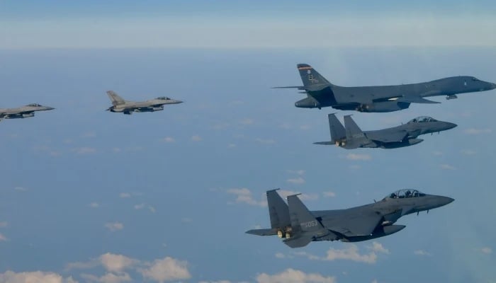 This photo taken on February 20, 2025, and provided by the South Korean Defence Ministry shows a US Air Force B-1B bomber (top right) flying over South Korea with South Korean Air Force F-15K fighter jets (bottom right) and US Air Force F-16 fighter jets (left) during a joint air drill in South Korea. — AFP