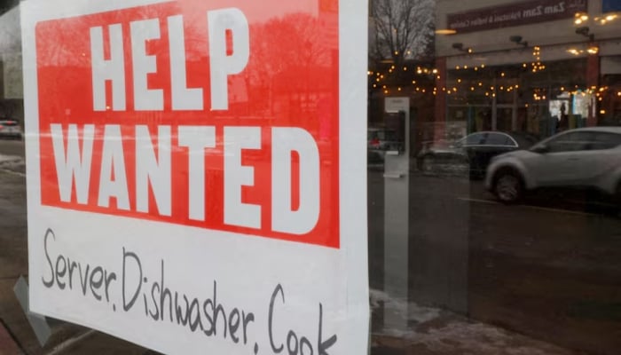 A “Help Wanted” sign hangs in restaurant window in Medford, Massachusetts, US, January 25, 2023.—Reuters
