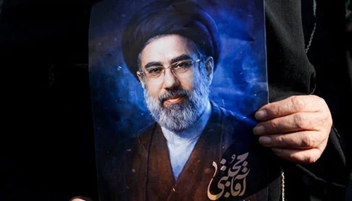 A woman holds a portrait of Irans new supreme leader Mojtaba Khamenei, on the day of a gathering to support Mojtaba Khamenei, amid the US-Israeli conflict with Iran, in Tehran, Iran, March 9, 2026. — Reuters