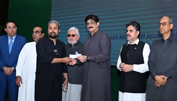 Sindh Chief Minister Murad Ali Shah distributes compensation cheques among the affectees of the Gul Plaza tragedy, on April 24, 2026. — Facebook@SindhCMHouse
