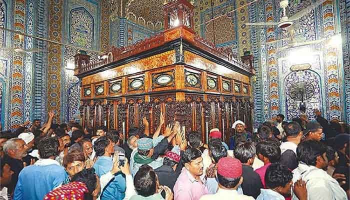 A large gathering of people pay homage to Shah Abdul Latif Bhittai at his shrine. — The News/File