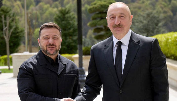 Ukraine’s President Volodymyr Zelensky and Azerbaijani President Ilham Aliyev shaking hands during their meeting in Qabala. —AFP