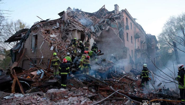 Rescue workers working after the deadly strike on the building in Dnipro. —AFP