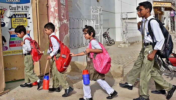 Students are going to their school in Larkana, on August 1, 2023. — APP