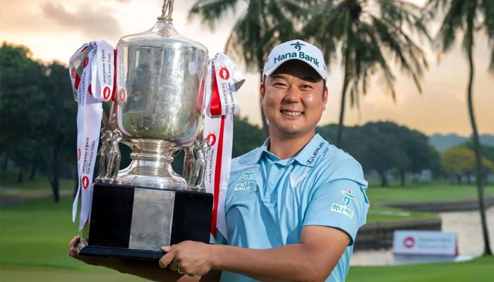 South Koreas Ham Jeong-woo is posing with the trophy after winning the Singapore Open golf tournament at the Sentosa Golf Club in Singapore on Sunday, April 26, 2026. — AFP