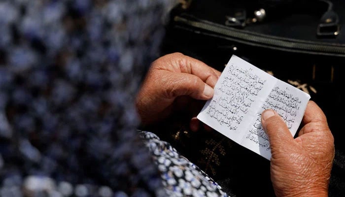 This representational image shows a woman reciting the Quran. — Reuters/File