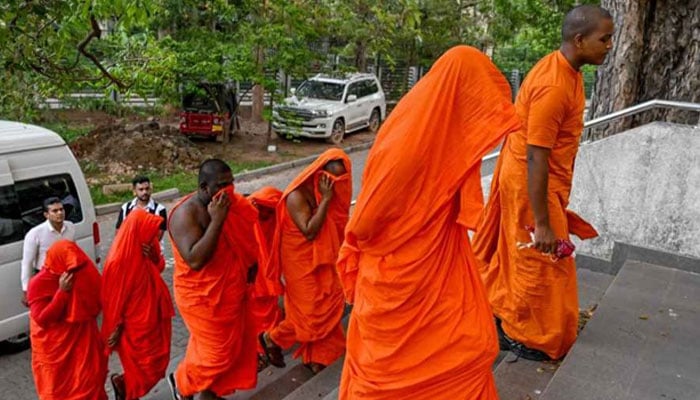 Sri Lankan monks arrive to appear before a court after their arrest in Negombo on 26 April 2026. — AFP