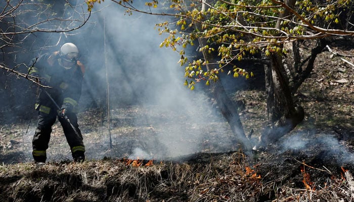 A firefighter works as wildfires continue in Otsuchi, Iwate Prefecture, Japan, April 26, 2026. — Reuters