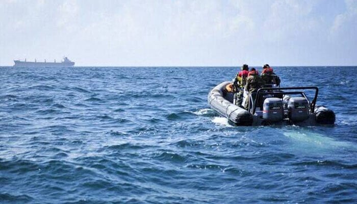 This representational image shows a rescue team heading towards a ship in the sea. — AFP