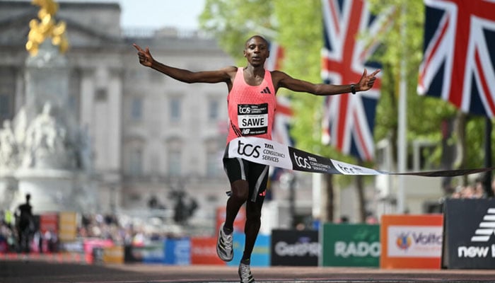 Sabastian Sawe crosses the London marathon finishing line in 1hr 59min 30sec, making him the first man to break the two-hour barrier in race conditions. —AFP