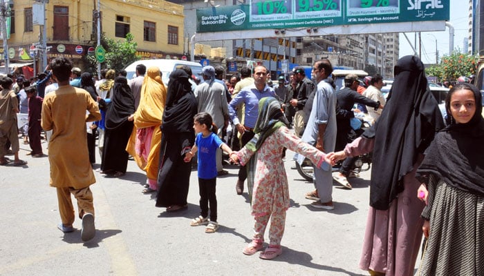 Residents of Railway Colony block the I I Chundrigar Road during a protest against electric load shedding in their area, in Karachi, on April 27, 2026. — ONLINE
