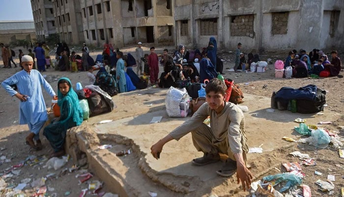 Afghan refugees wait at the Karachi bus terminal to depart for Afghanistan, in Sindh province on October 31, 2023. — AFP