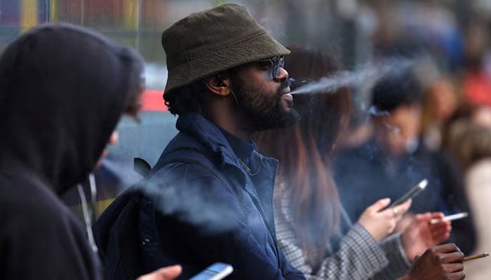People smoke in London, Britain, April 16, 2024.—Reuters