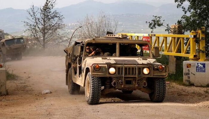 Israeli army soldiers patrol in their Humvees along the border with southern Lebanon, in the Upper Galilee of northern Israel, April 25, 2026.—AFP