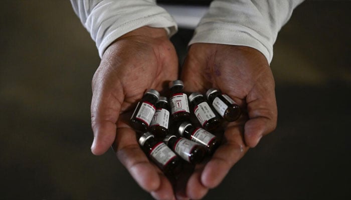 A health ministry worker showing vaccine doses for an immunisation campaign in Guatemala. —AFP/File
