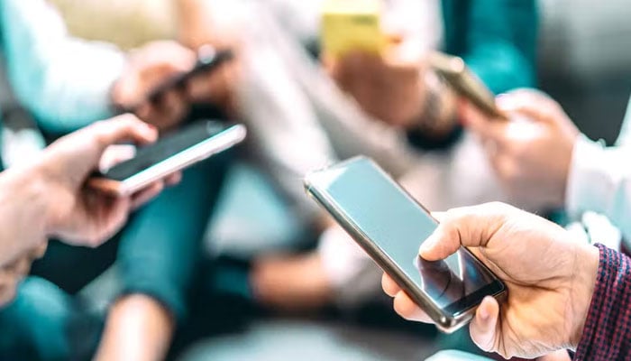A representational image of people using mobile phones.—TheNews/File