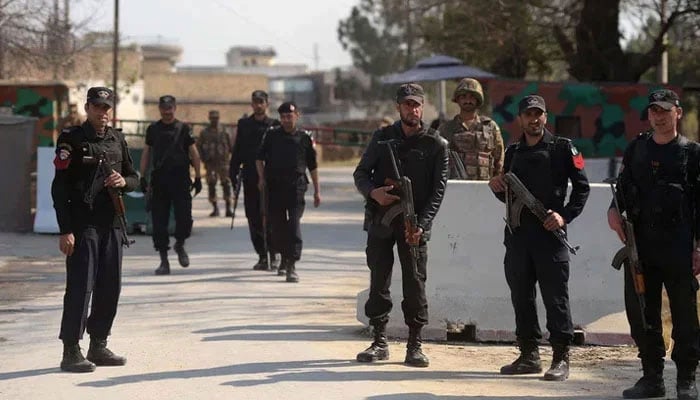 The KP police personnel stand guard in an unspecified area in KP. — AFP/File