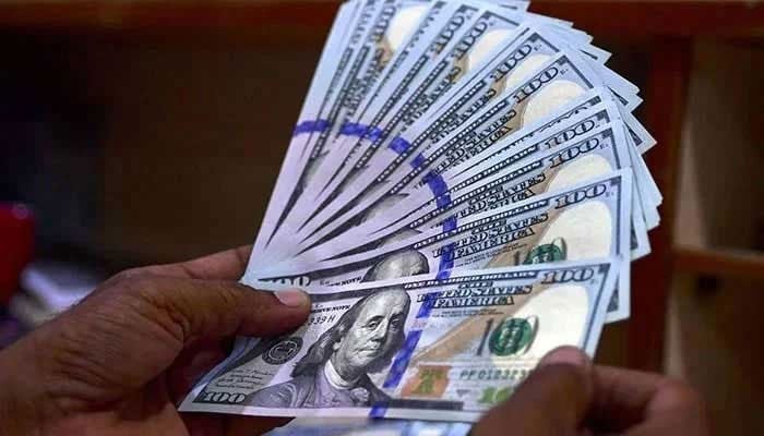 A foreign currency dealer counts US dollars in Karachi on July 19, 2022. — AFP