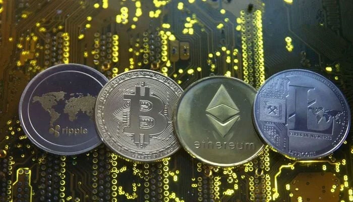 Representations of the Ripple, Bitcoin, Etherum and Litecoin virtual currencies are seen on a PC motherboard in this illustration picture on February 14, 2018. — Reuters