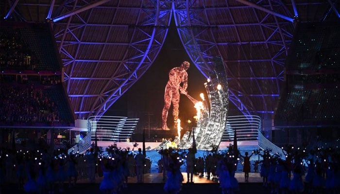 A digital torch bearer gets the Asian Games torch during the opening ceremony of the 2022 Asian Games at the Hangzhou Olympic Sports Centre Stadium in Hangzhou in Chinas eastern Zhejiang province on September 23, 2023.—AFP