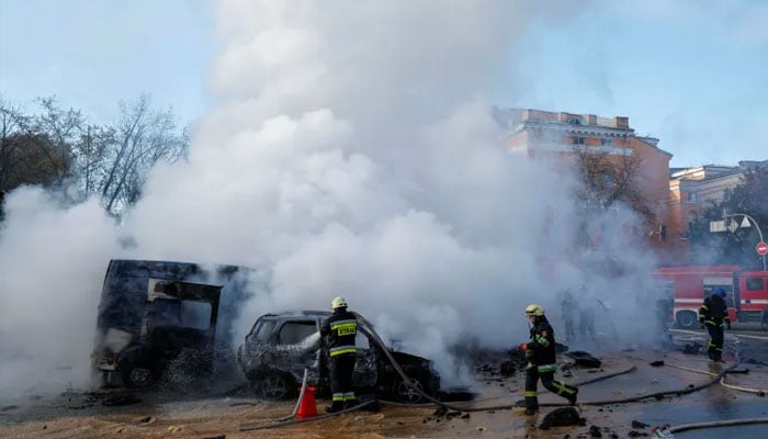 Firefighters work to put out fire at the scene of a missile attack in Kyiv.—Reuters