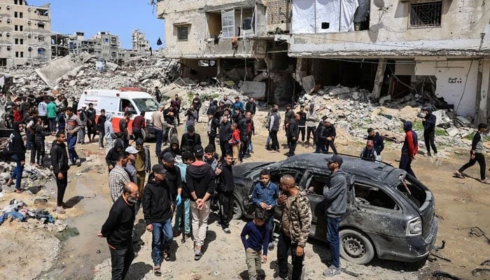 Palestinians inspect the damage after a person was hit by an Israeli strike while riding a bicycle, according to medics, in Gaza City, April 6, 2026. — Reuters