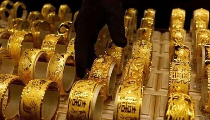 A salesperson arranges 24K gold bracelets for Chinese weddings at Chow Tai Fook Jewellery store in Hong Kong, China.— Reuters/File