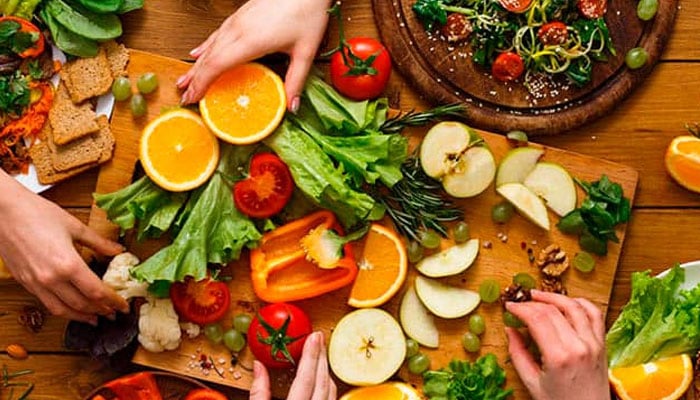 The representational  image shows a vibrant table setting focused on healthy eating, featuring fresh fruits, vegetables, and whole-grain bread. — Mayo Clinic website/File