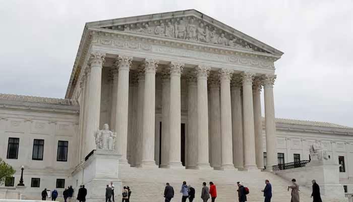People walk across the plaza of the US Supreme Court building on the first day of the courts new term in Washington, US.— Reuters