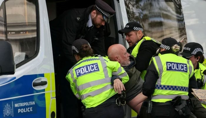 Police officers detain a protester at Everyone Day, a mass vigil and sign-holding event in Trafalgar Square organised by Defend Our Juries to demand the lifting of the ban on Palestine Action, in London, Britain, April 11, 2026. —Reuters