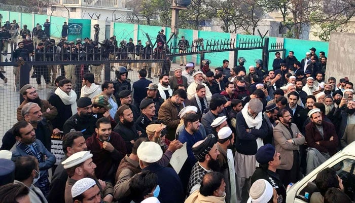 Protesters block the road as they are holding a protest demonstration outside the Provincial Assembly building in Peshawar on January 5, 2026. — PPI