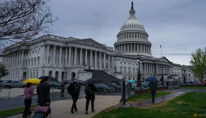 People walk near the US Capitol building on Capitol Hill in Washington, DC, US, Mar 27, 2026.—Reuters