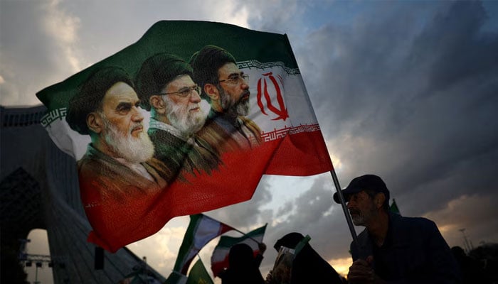 A man holds a flag during a rally in Tehran. — Reuters/File