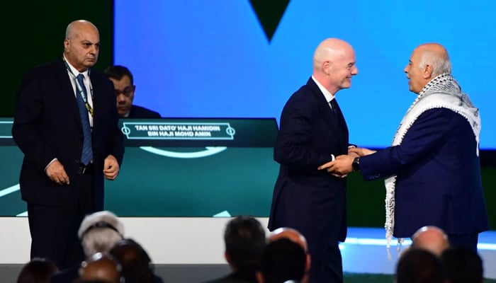 Fifa President Gianni Infantino (C) interacts with the President of the Palestine Football Association Jibril Rajoub as the Vice-President of Israel Football Association Basim Sheikh Suliman (L) looks on during a heated moment in the 76th Fifa Congress in Vancouver, Canada on April 30, 2026. — AFP